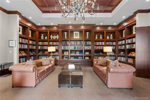 a living room with fireplace furniture and a book shelf