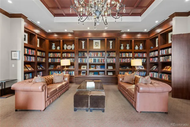 a living room with fireplace furniture and a book shelf