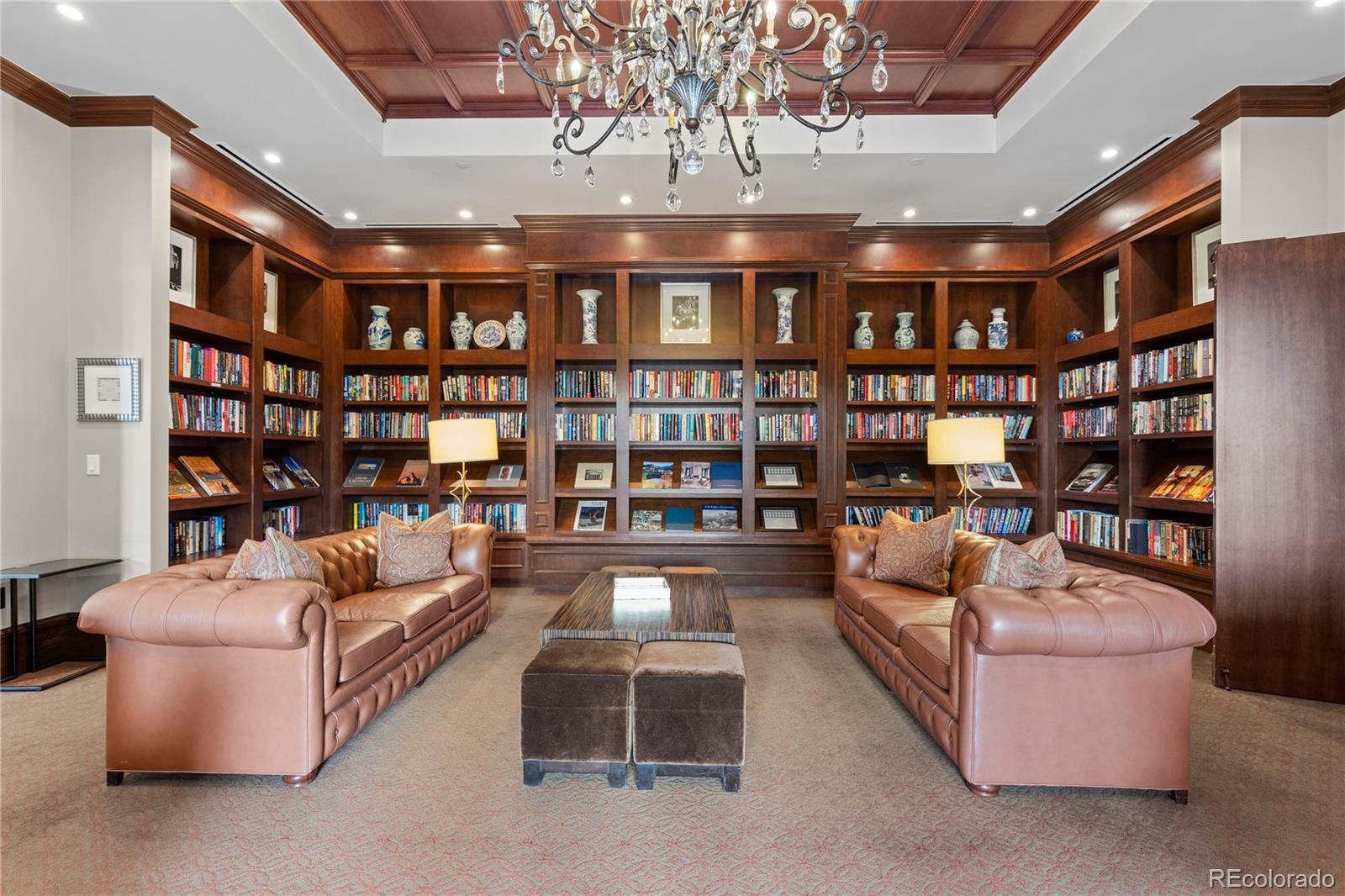 7600 Land Mark Way, Unit 1411 Greenwood Village, CO 80111 - Photo 39 of 50 a living room with fireplace furniture and a book shelf