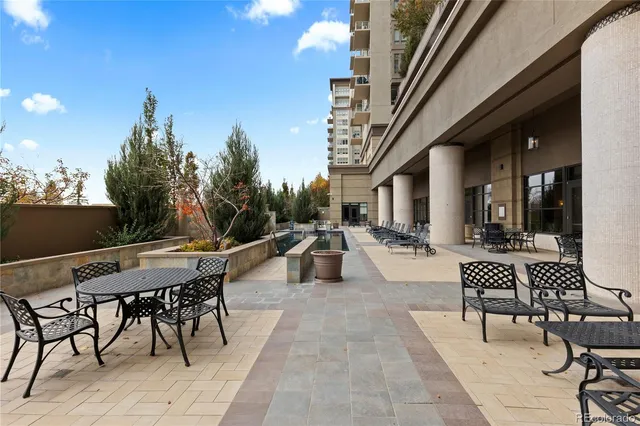 a view of a patio with dining table and chairs