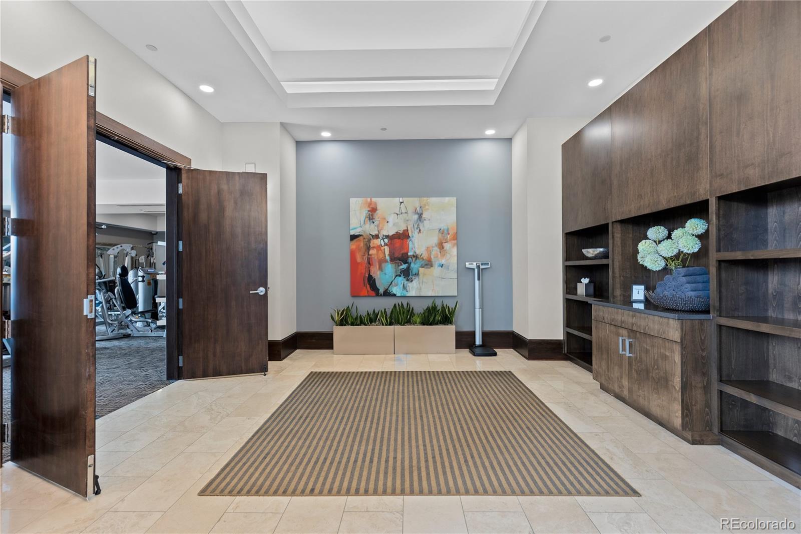 7600 Land Mark Way, Unit 1411 Greenwood Village, CO 80111 - Photo 46 of 50 a living room with stainless steel appliances furniture a rug and a projector