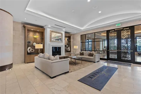a living room with furniture large window and a fireplace