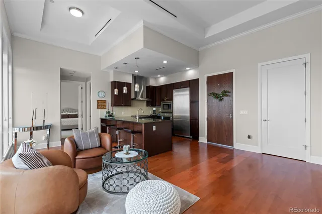 a large living room with stainless steel appliances kitchen island granite countertop furniture and a kitchen view