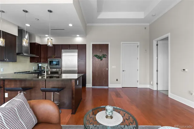 a open kitchen with cabinets a sink and a refrigerator