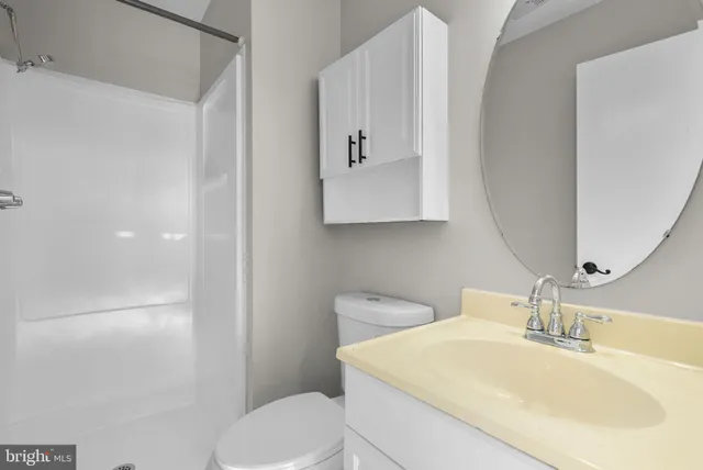 a bathroom with a sink toilet and mirror