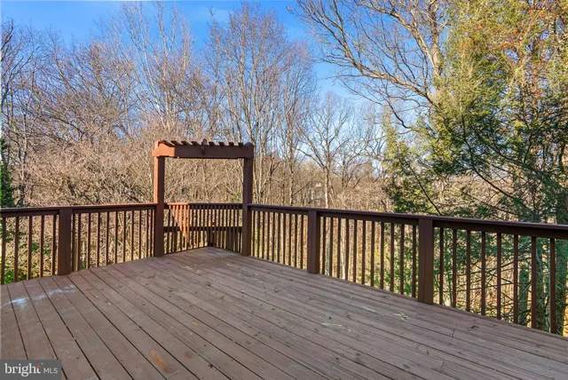 a balcony with wooden floor and fence