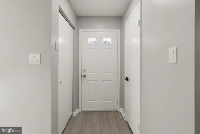 a view of a hallway with wooden floor