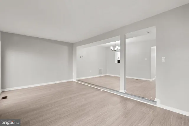 wooden floor in an empty room with a bathroom