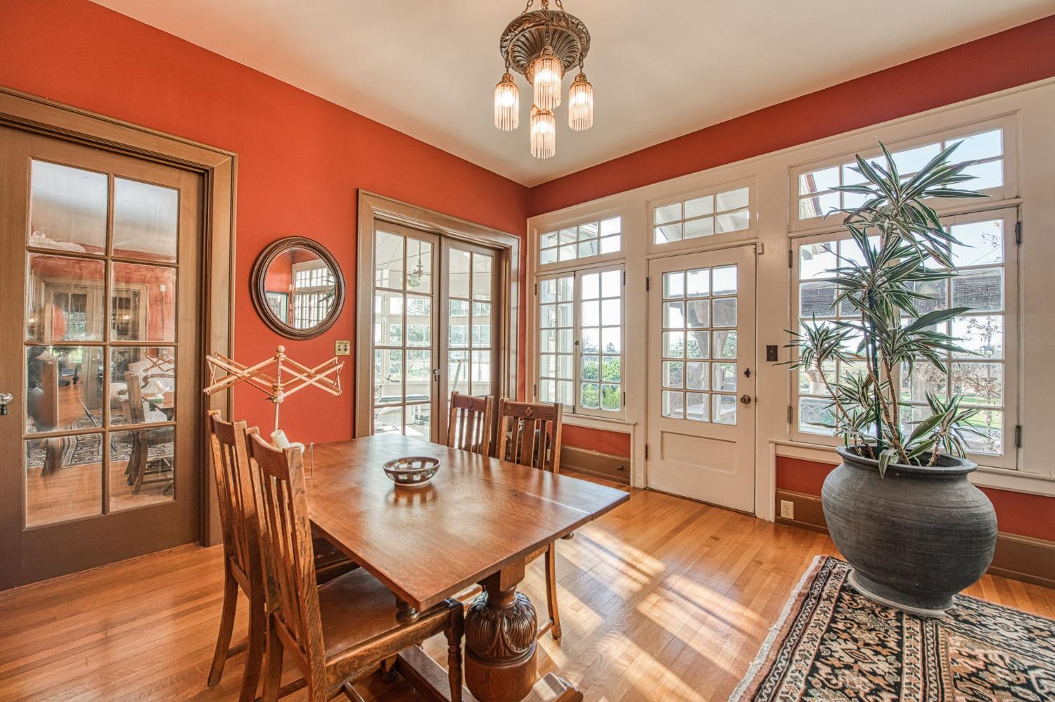 9486 East Lincoln Avenue Del Rey, CA 93616 - Photo 11 of 77 a view of a dining room with furniture a chandelier and wooden floor