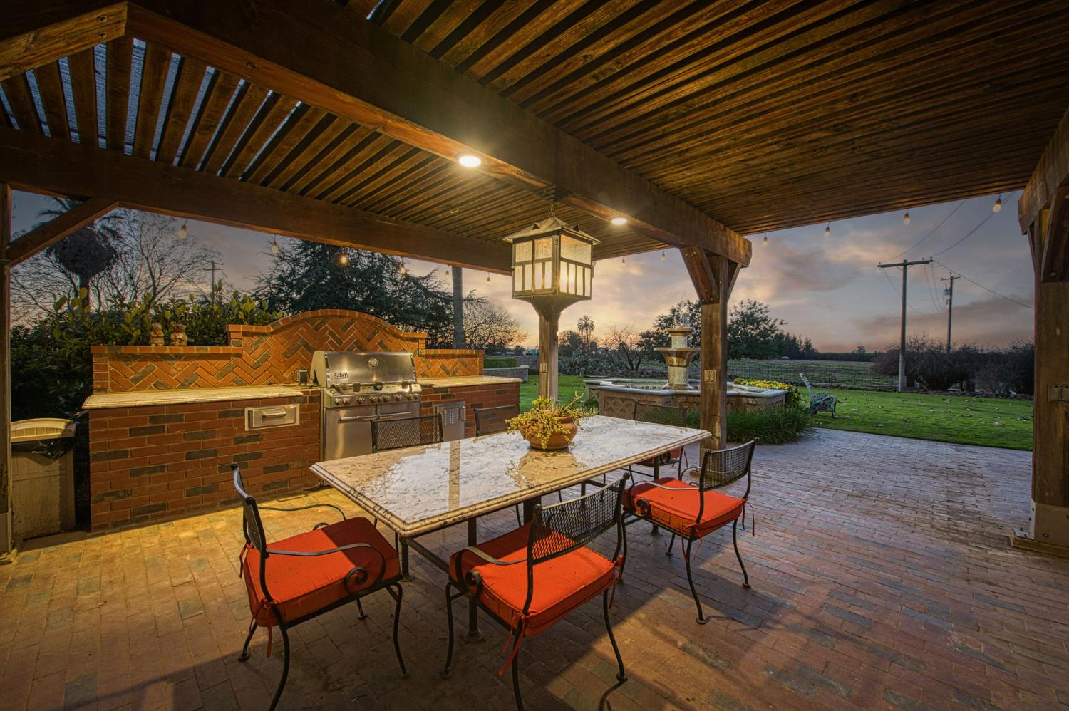 9486 East Lincoln Avenue Del Rey, CA 93616 - Photo 65 of 77 a view of a patio with table and chairs with wooden floor and fence