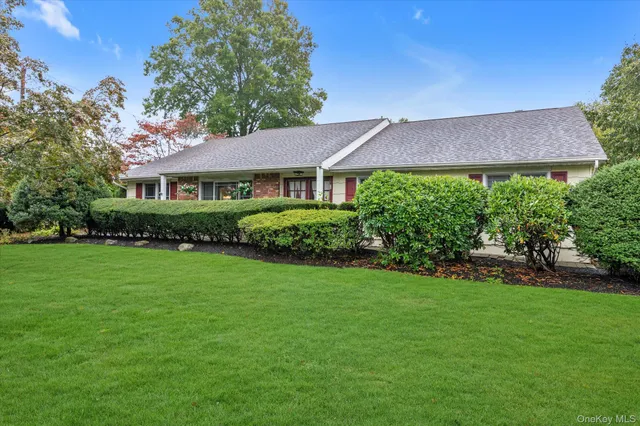 a view of a house with garden and yard