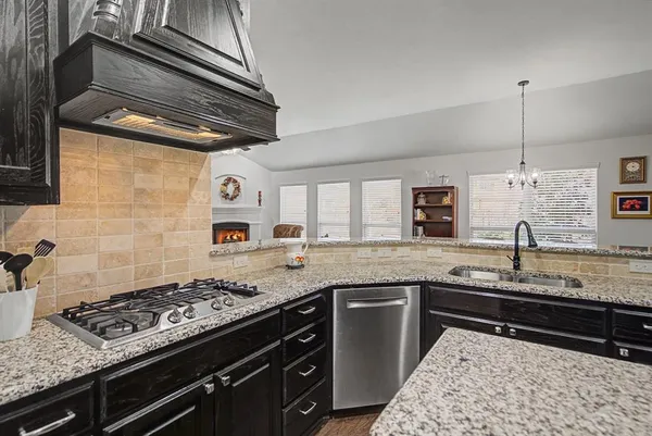 a kitchen with a stove and a sink