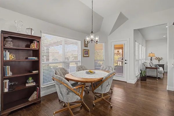 a view of a dining room with furniture and wooden floor