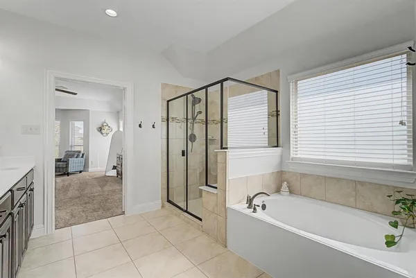 a bathroom with a bathtub and a shower