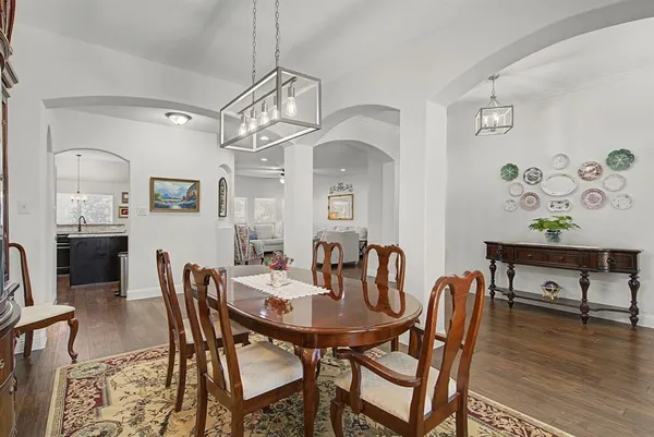 a view of a dining room with furniture wooden floor and a chandelier