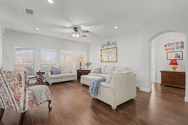 a living room with furniture and wooden floor