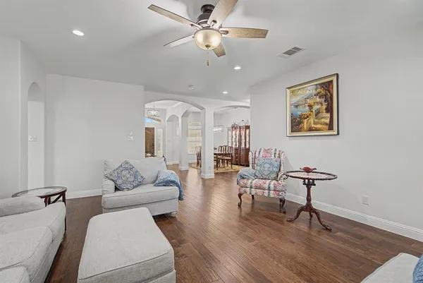 a living room with furniture and a chandelier