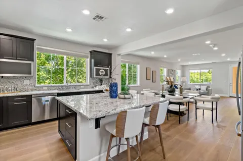 a kitchen with a sink and large window