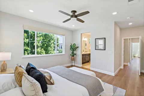 a bedroom with a large bed and a window