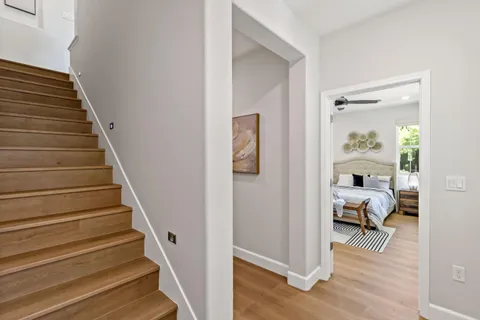 a view of a hallway with wooden floor and entryway