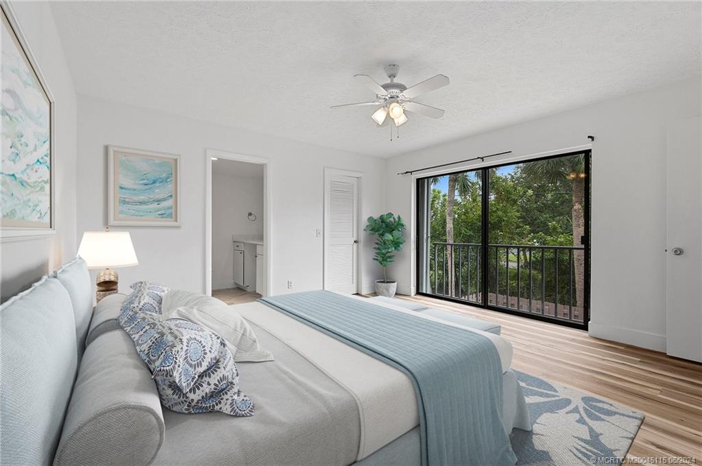 762 Northwest 10th Terrace Stuart, FL 34994 - Photo 12 of 41 a bedroom with a large bed and a window