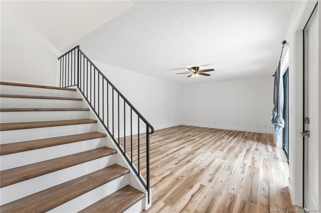 762 Northwest 10th Terrace Stuart, FL 34994 - Photo 13 of 41 a view of a livingroom with wooden floor and stairs