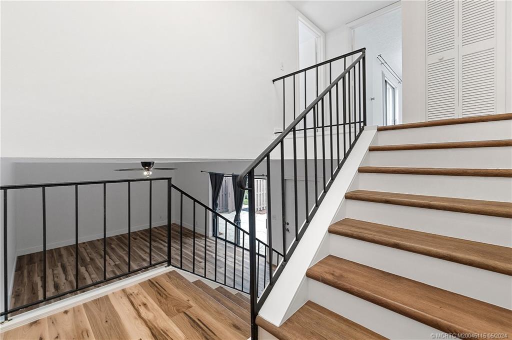 762 Northwest 10th Terrace Stuart, FL 34994 - Photo 23 of 41 a view of staircase with wooden floor and a stairs