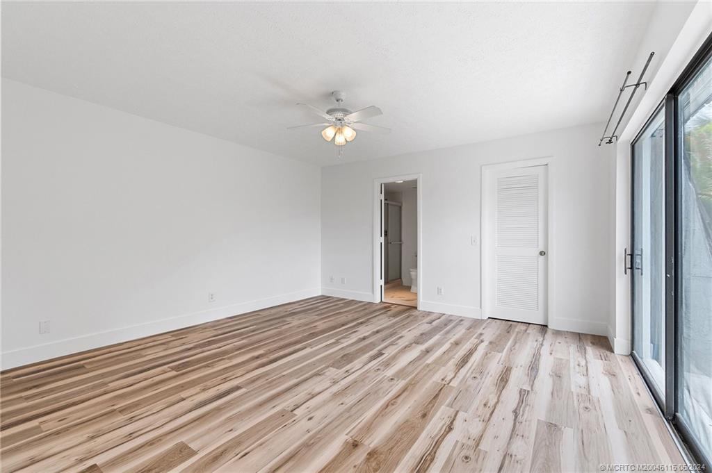 762 Northwest 10th Terrace Stuart, FL 34994 - Photo 25 of 41 wooden floor in an empty room with a window