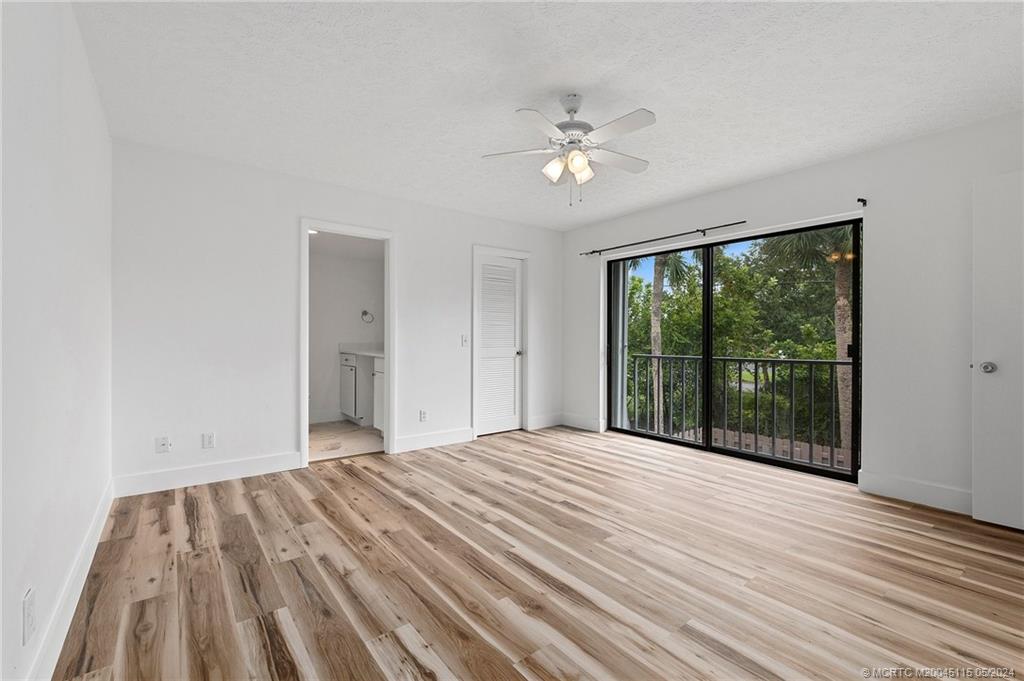 762 Northwest 10th Terrace Stuart, FL 34994 - Photo 26 of 41 a view of an empty room with wooden floor and a window