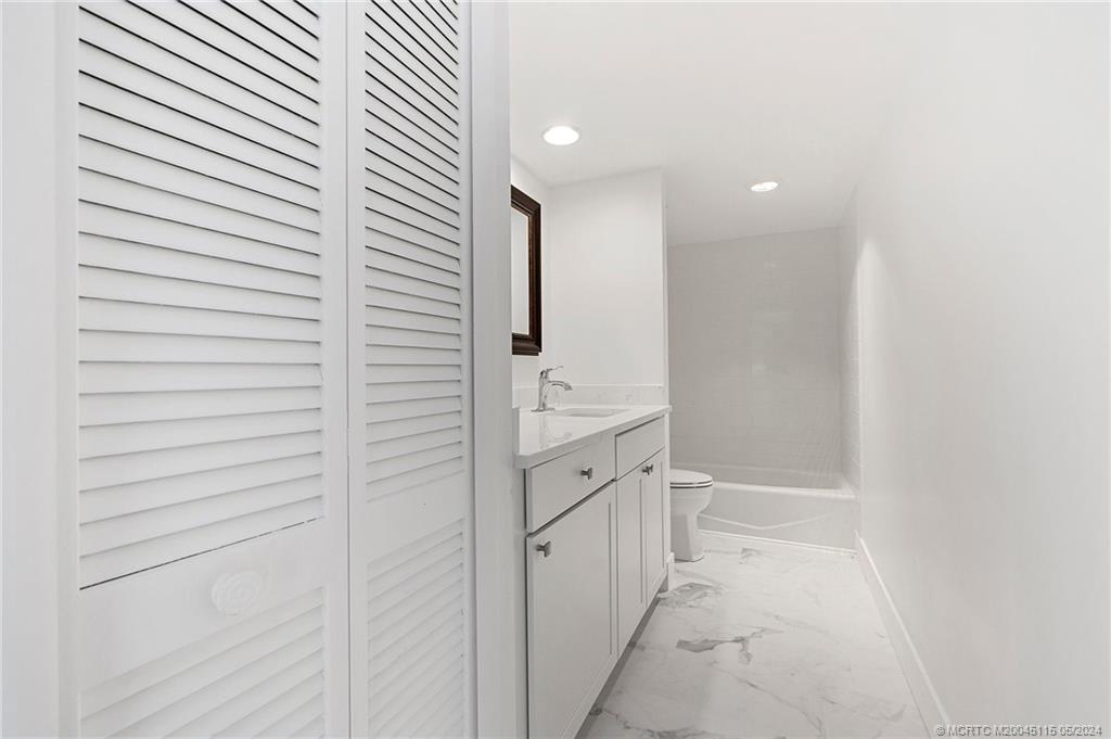 762 Northwest 10th Terrace Stuart, FL 34994 - Photo 32 of 41 a bathroom with a bathtub and a sink