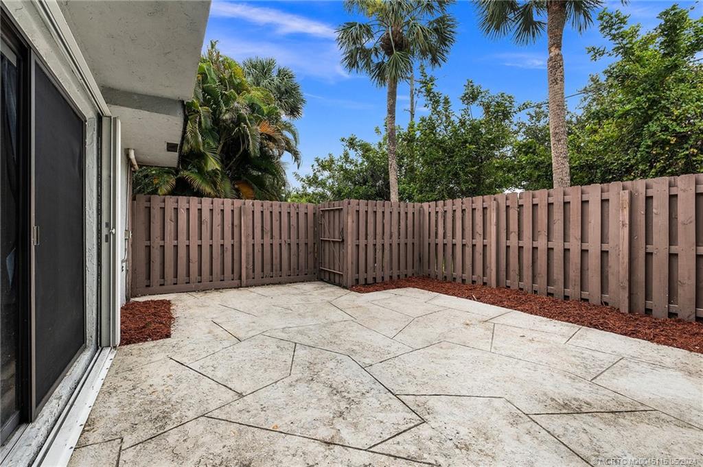 762 Northwest 10th Terrace Stuart, FL 34994 - Photo 37 of 41 a view of backyard with wooden fence and trees