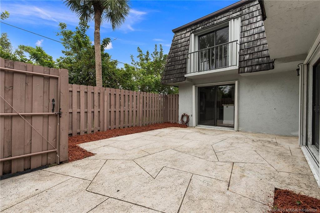 762 Northwest 10th Terrace Stuart, FL 34994 - Photo 5 of 41 a backyard of a house with palm tree