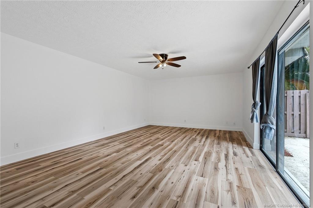 762 Northwest 10th Terrace Stuart, FL 34994 - Photo 10 of 41 wooden floor in a empty room
