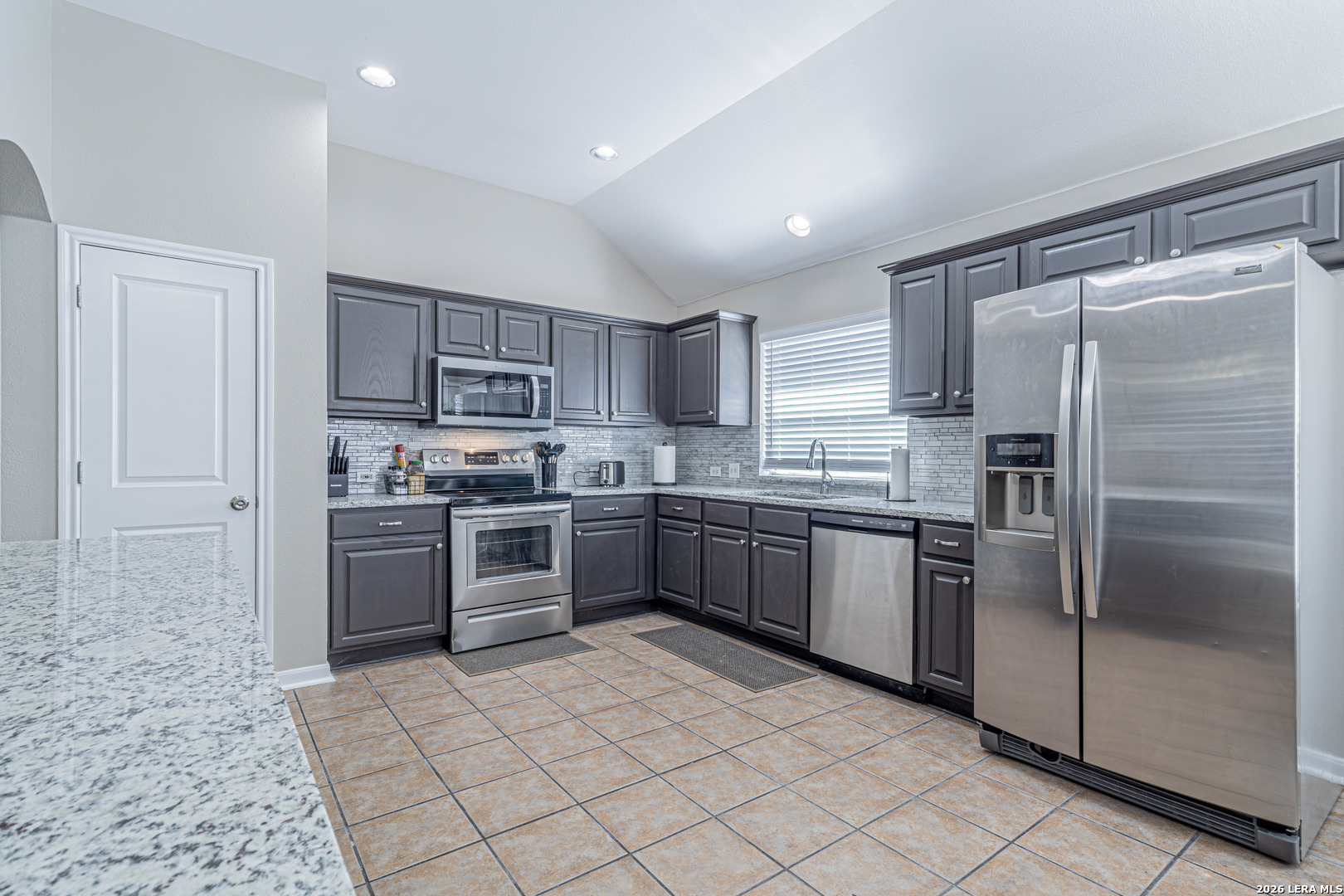 1815 Indian Paint Brush Road San Antonio, TX 78232 - Photo 11 of 35 a kitchen with stainless steel appliances granite countertop a refrigerator sink and cabinets