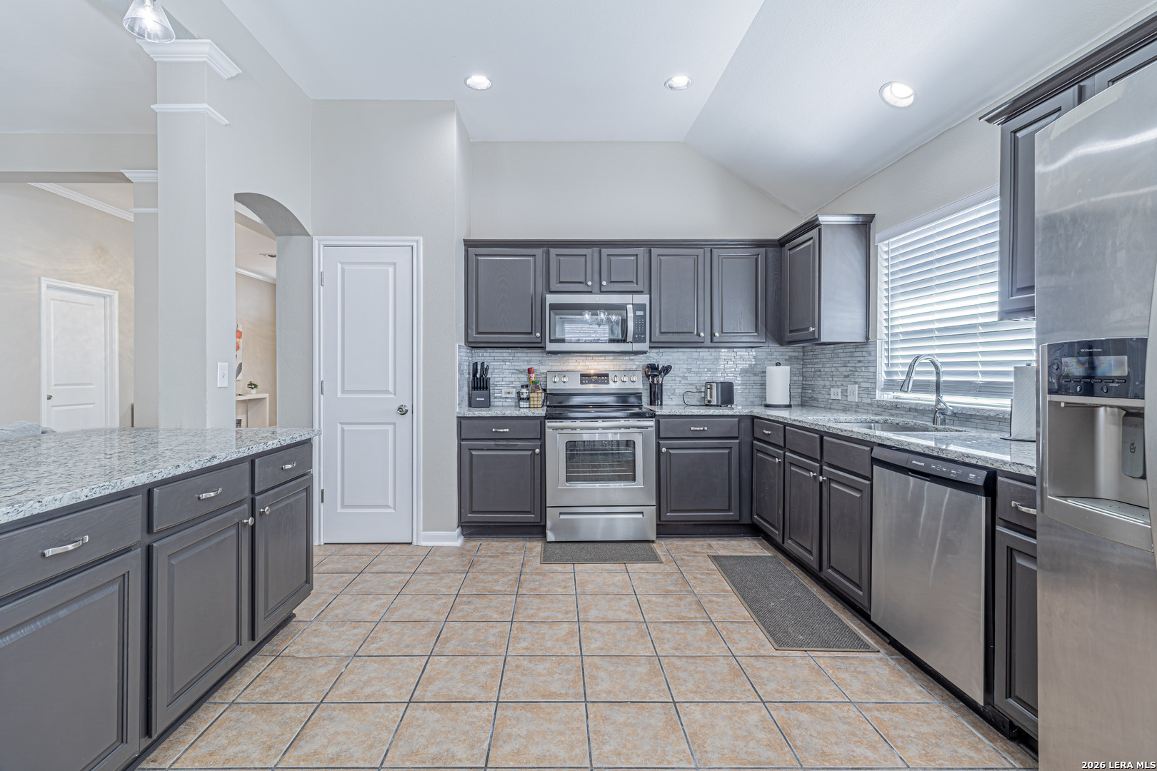 1815 Indian Paint Brush Road San Antonio, TX 78232 - Photo 12 of 35 a kitchen with stainless steel appliances granite countertop a stove sink and cabinets