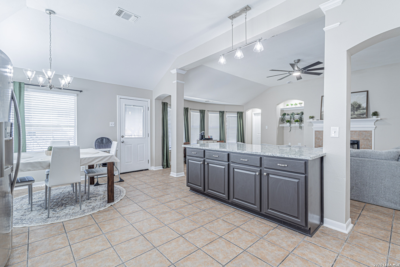 1815 Indian Paint Brush Road San Antonio, TX 78232 - Photo 14 of 35 a large kitchen with kitchen island granite countertop a refrigerator a sink dishwasher a dining table and chairs with wooden floor