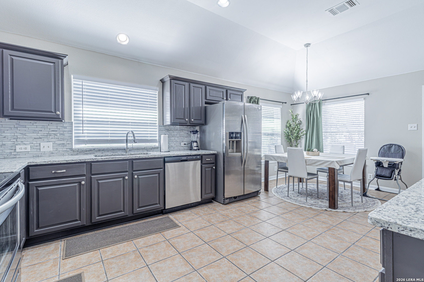 1815 Indian Paint Brush Road San Antonio, TX 78232 - Photo 15 of 35 a kitchen with granite countertop cabinets a dining table and chairs