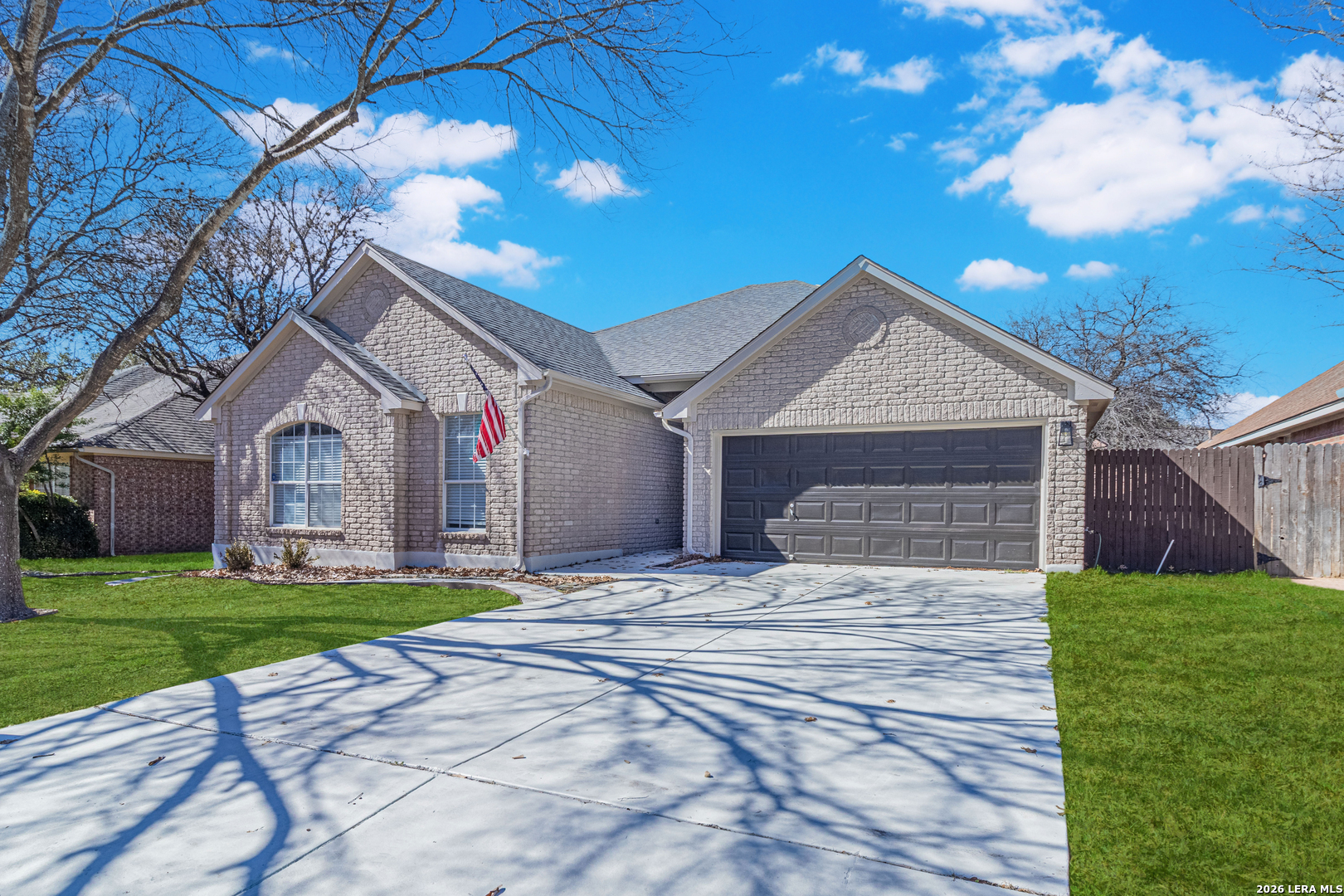 1815 Indian Paint Brush Road San Antonio, TX 78232 - Photo 2 of 35 a front view of a house with a yard and garage