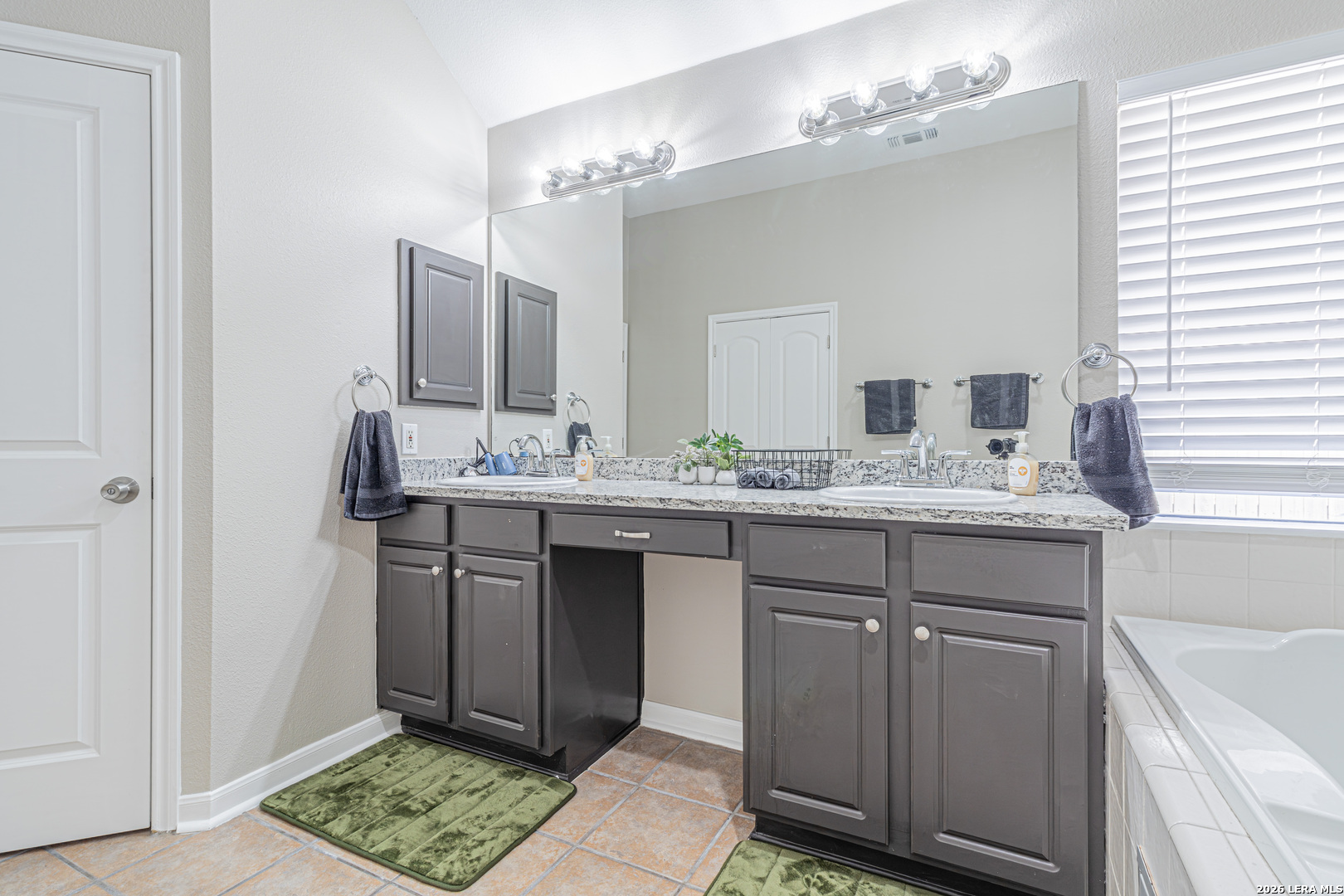 1815 Indian Paint Brush Road San Antonio, TX 78232 - Photo 23 of 35 a bathroom with a sink double vanity and a mirror
