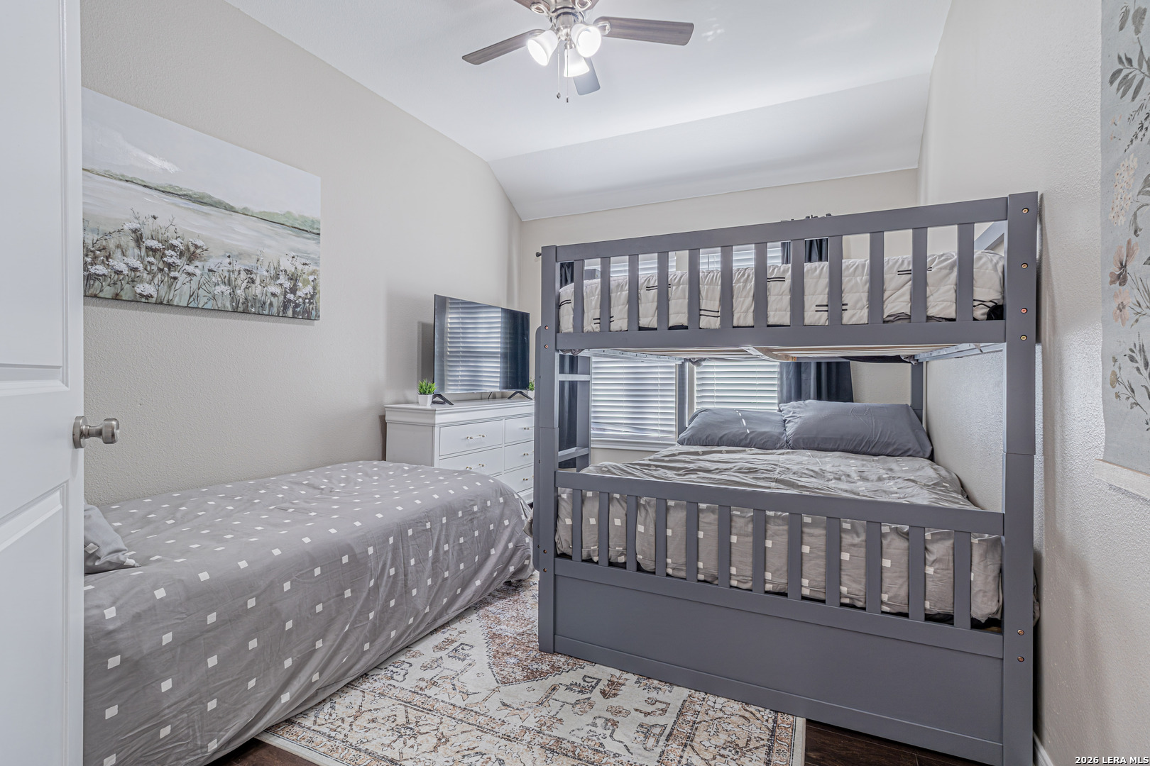 1815 Indian Paint Brush Road San Antonio, TX 78232 - Photo 25 of 35 a bedroom with a large bed and a chandelier