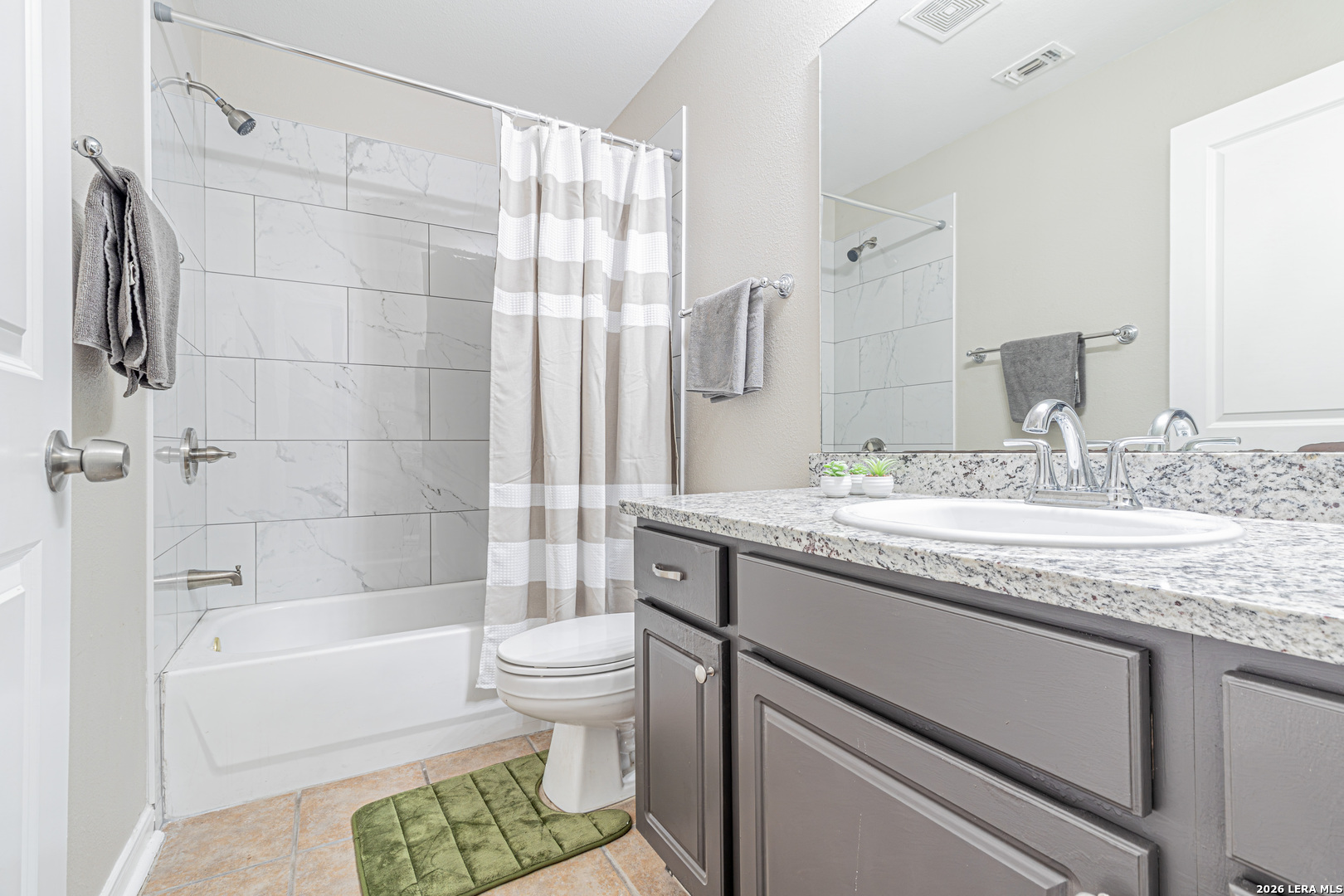 1815 Indian Paint Brush Road San Antonio, TX 78232 - Photo 30 of 35 a bathroom with a granite countertop sink a toilet and shower