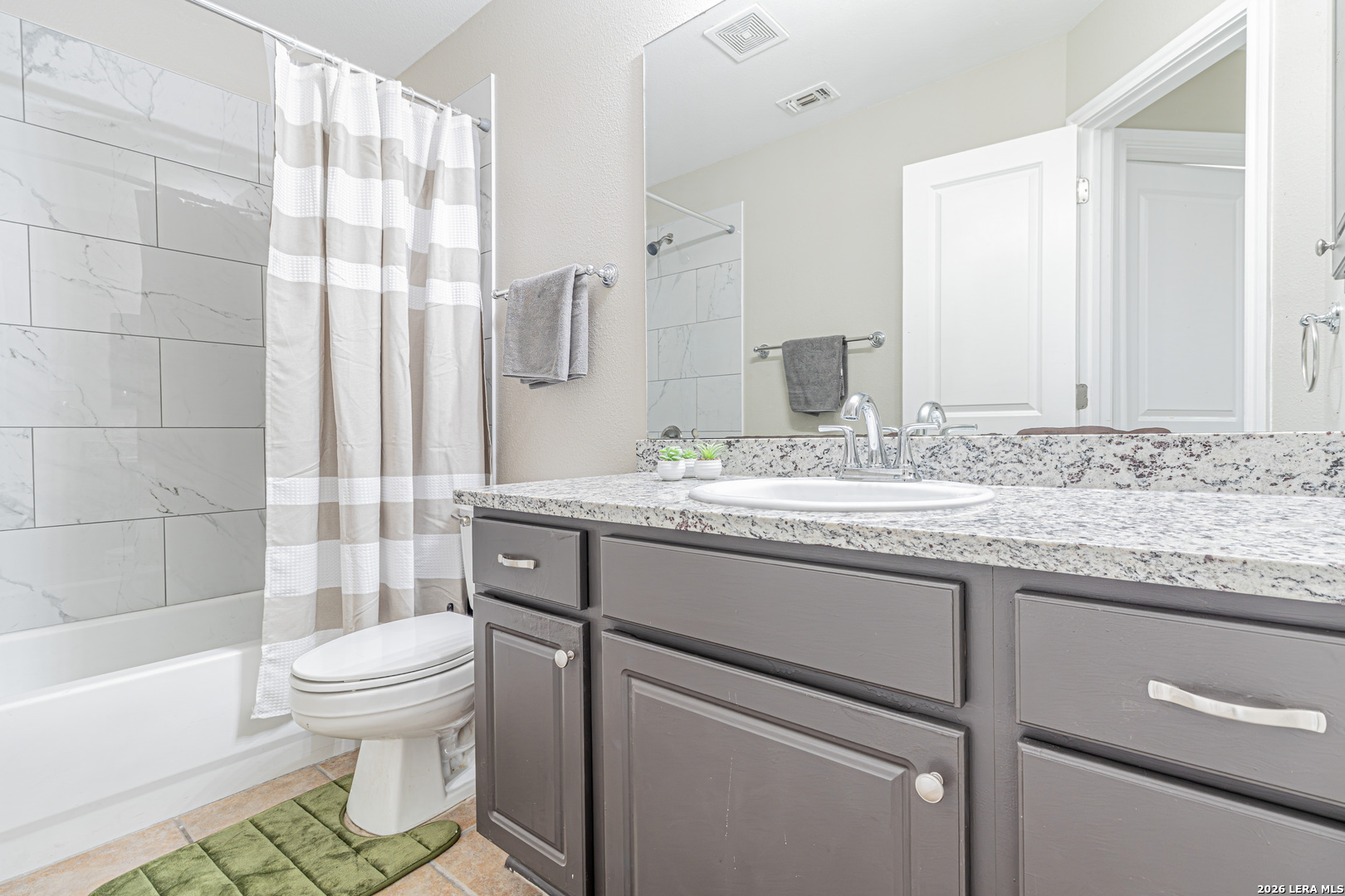 1815 Indian Paint Brush Road San Antonio, TX 78232 - Photo 31 of 35 a bathroom with a granite countertop sink toilet mirror and shower
