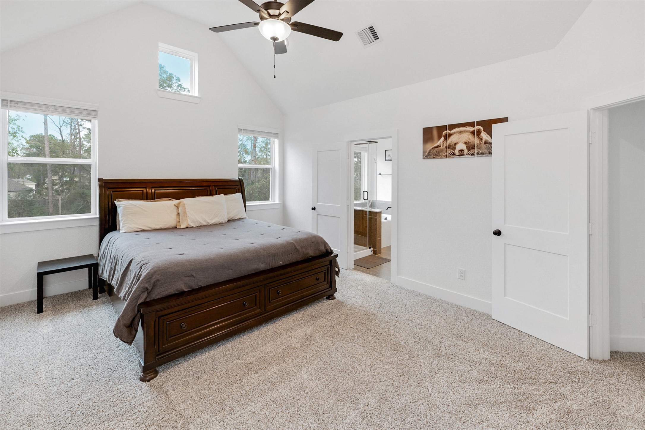 144 Red Cascade Trail Conroe, TX 77318 - Photo 13 of 34 The primary bedroom is large and spacious. It has an en-suite bathroom.