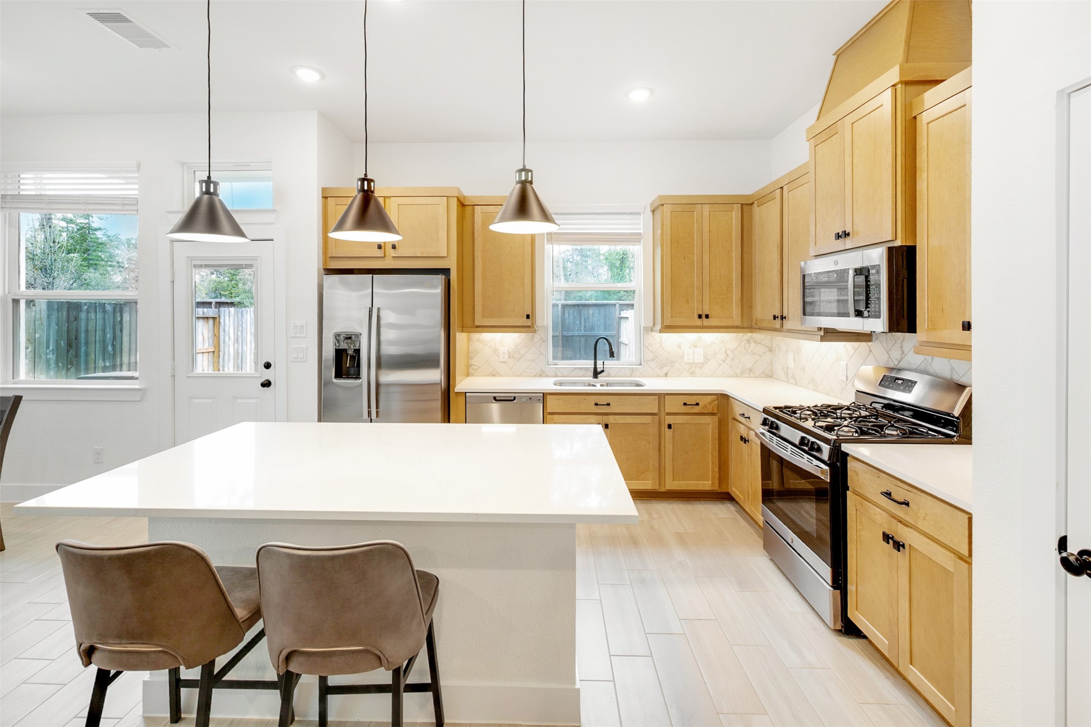 144 Red Cascade Trail Conroe, TX 77318 - Photo 8 of 34 Gorgeous!! Your kitchen offers tons of storage and plenty of counter space, plus stainless appliances.