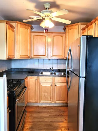 a kitchen with stainless steel appliances granite countertop a refrigerator and a sink