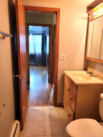 a bathroom with a sink a toilet and mirror