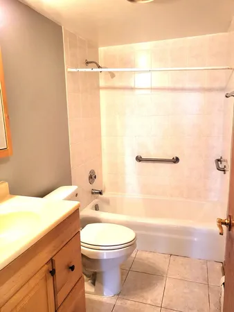 a bathroom with a toilet a sink and bathtub