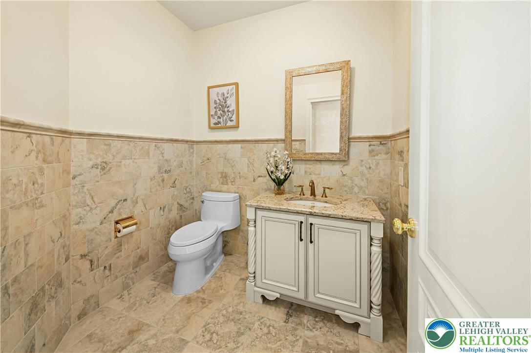 3200 Creamery Road New Hope, PA 18938 - Photo 16 of 42 a bathroom with a granite countertop toilet a sink and a mirror