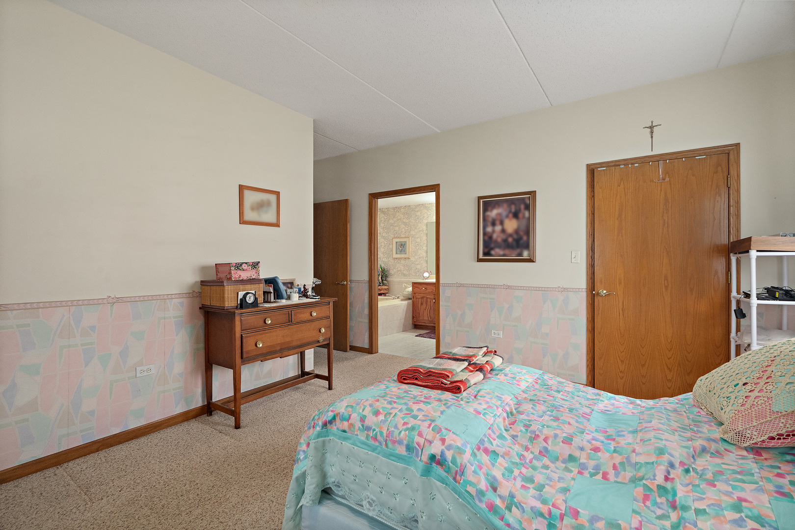 18431 Pine Cone Drive, Unit 1 Tinley Park, IL 60477 - Photo 14 of 33 a bedroom with a bed and a table in it