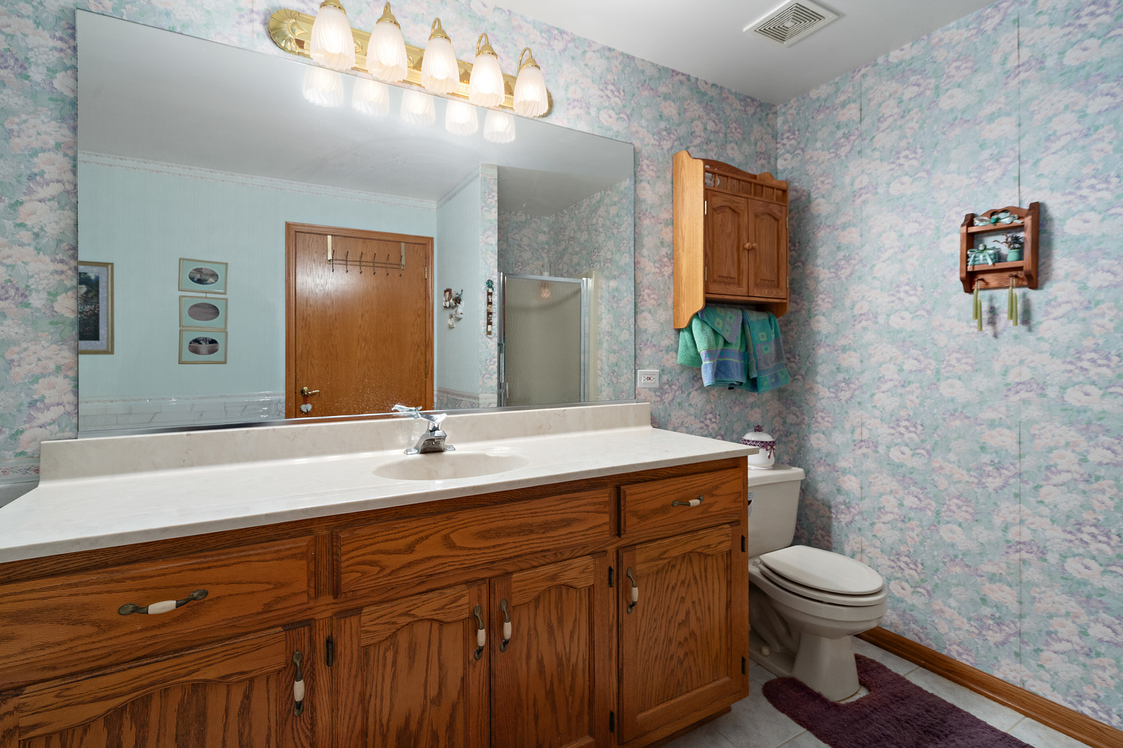 18431 Pine Cone Drive, Unit 1 Tinley Park, IL 60477 - Photo 16 of 33 a bathroom with a granite countertop toilet sink and mirror